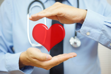 doctor is protecting heart  with hands. Health care and  Cardiov