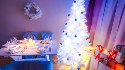 Beautiful Christmas table setting with blue and white decoration