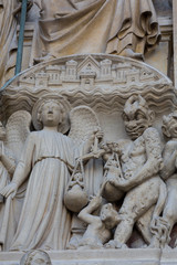 Fototapeta na wymiar Paris - West facade of Notre Dame Cathedral. The Last Judgment tympanum