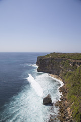 Calm sea with clear water and green coast in Bali