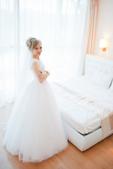 gentle blonde  bride on couch tenderly posed