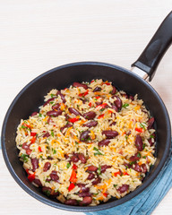 Rice with red beans and vegetables in a frying pan