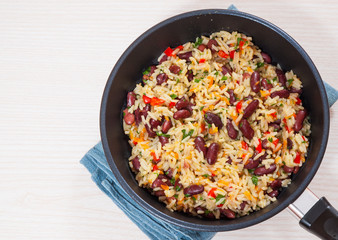 Rice with red beans and vegetables in a frying pan