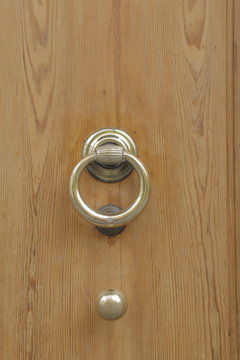 Wooden door with old bronze handles and knob