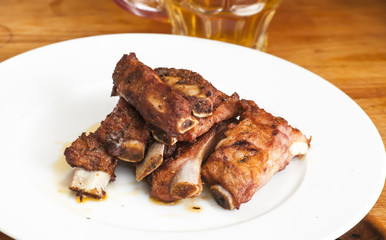 Roasted pork ribs on a white plate