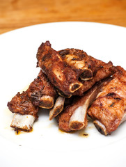 Roasted pork ribs on a white plate
