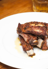 Roasted pork ribs on a white plate