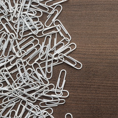 white paper clips on wooden table