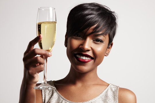 woman with a glass of champagne. Celebrating and smiling