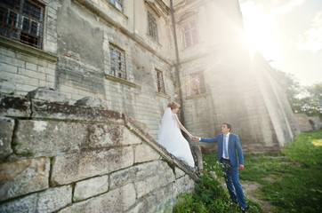 Fototapeta na wymiar Tender wedding couple background old architecture of castle