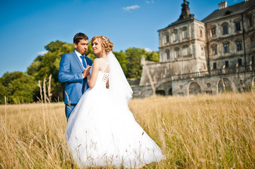 Tender wedding couple background old architecture of castle