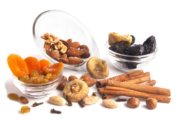 Nuts, spices and dried fruit mix isolated on white.