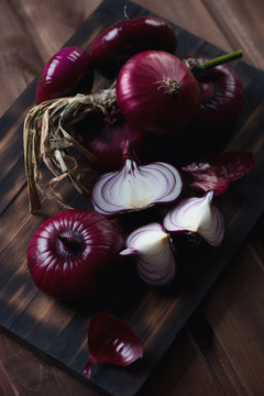 Close-up of red onion on a rustic wooden chopping board