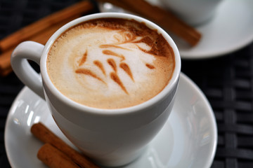 White Cup Of Foamy Cappuccino On A Black Background