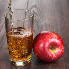 fresh apple juice pouring into glass
