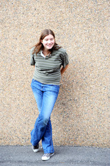 Female tomboy expressions against a wall outside.