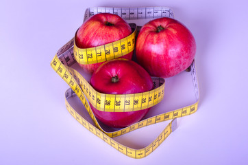 apples with measuring tape on white background