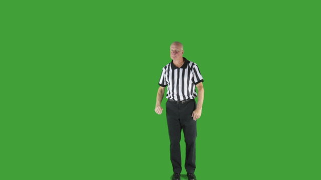 Man dressed in basketball referee uniform signaling the direction of play.