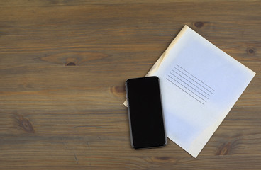 Notebooks, smartphone on a wooden table