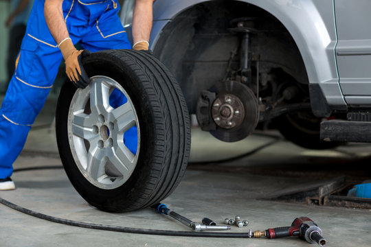 mechanic changing a wheel of a modern car