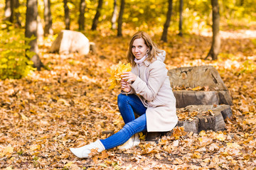 pretty woman relaxing in the autumn park