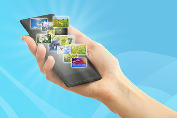 Hand holding smart phone with streaming images
