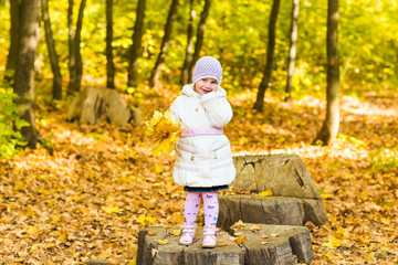 Little girl with yellow leaf.