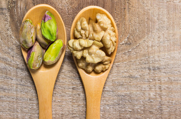 Closeup of a walnut and pistachios.