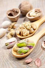 Closeup of a walnut and pistachios.