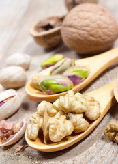 Closeup of a walnut and pistachios.