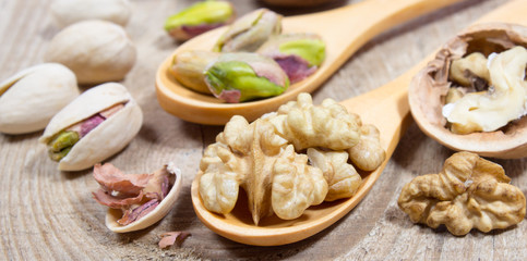 Closeup of a walnut and pistachios.