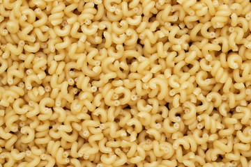 dry uncooked cavatappi pasta texture background