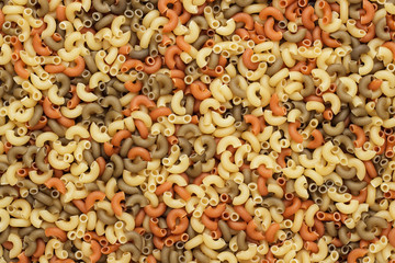 dry uncooked colored pasta texture background