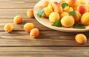 Ripe apricots on wooden table, closeup
