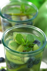 Kiwi and Blueberry cocktails on wooden background