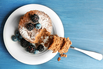 Cake with berries on wooden table