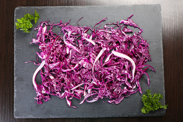 Cut red cabbage on wooden table