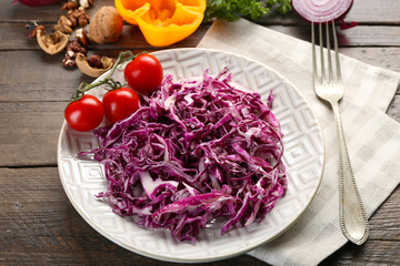 Red cabbage salad served on plate closeup