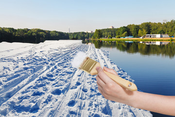 paintbrush paints snow field in summer lake