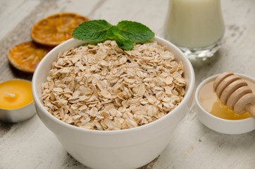 Oatmeal with honey , raisins, mint and orange slice