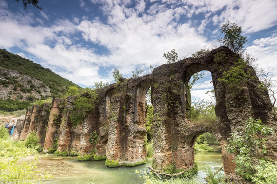 Roman aqueduct of Nikopolis against beautiful cloudy sky in Gree