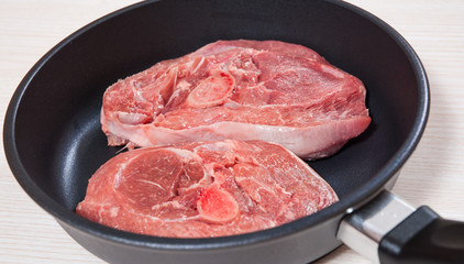 Raw meat  in a frying pan
