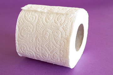 Roll of toilet paper on a purple background