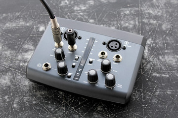 Audio interface for recording or mixing - sound/audio card - cables for guitar and other instruments on grunge background