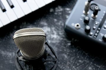Microphone, audio card and piano keys on grunge background