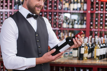 Attractive male waiter is working in liquor store