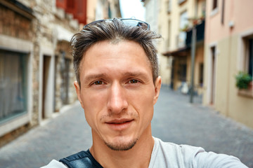 Fototapeta premium young man on the old town background