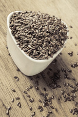 Flax seeds linseed in bowl on wooden table