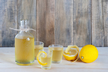 Homemade limonchello on the wooden background