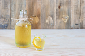 Homemade limonchello on the wooden background